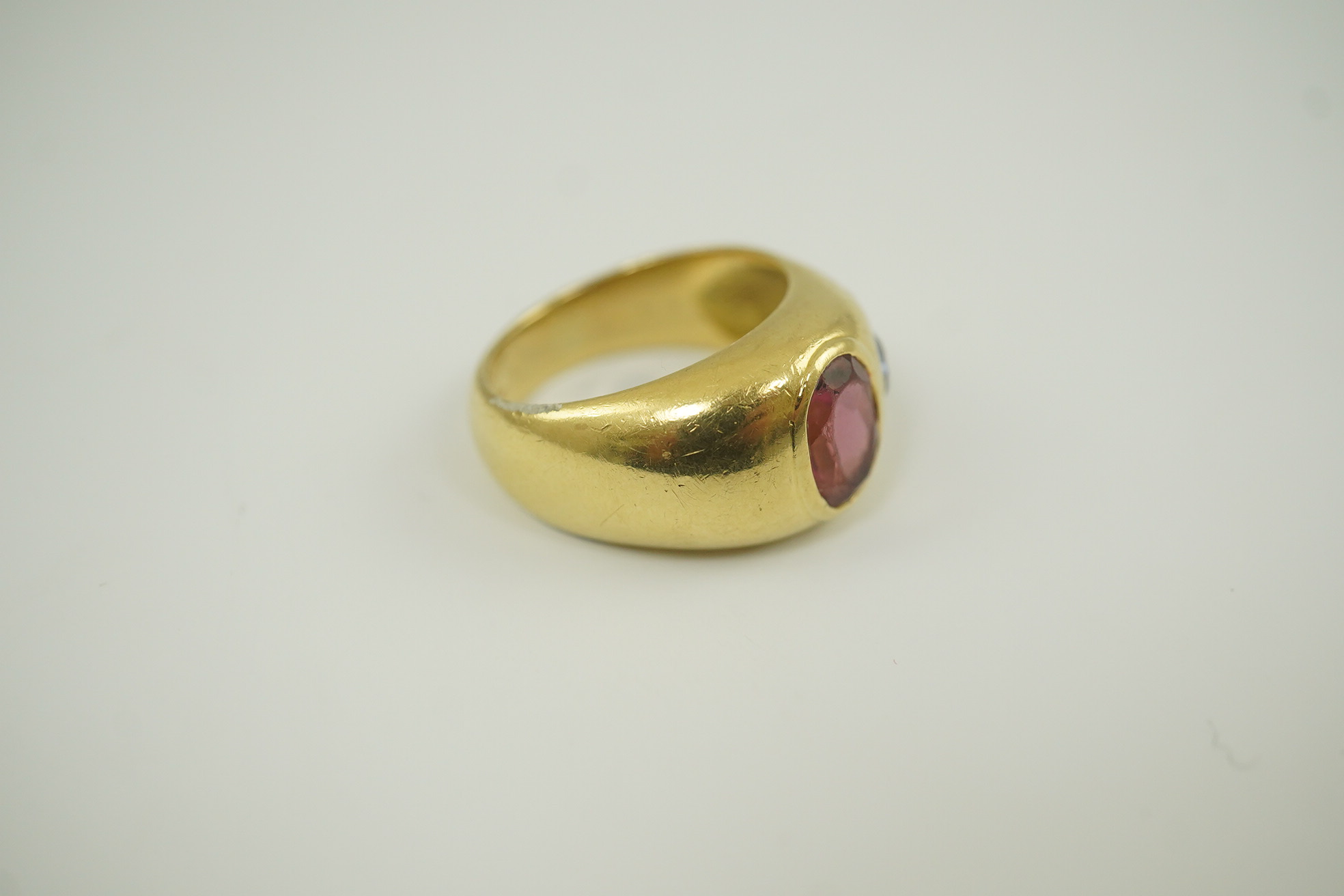 A modern Mappin & Webb 18ct gold and gypsy set pink tourmaline and blue sapphire set dress ring